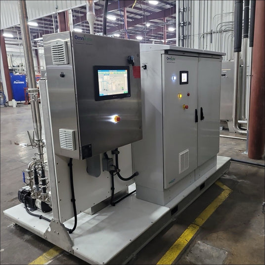 Industrial equipment with a control panel and various connections in a warehouse setting.
