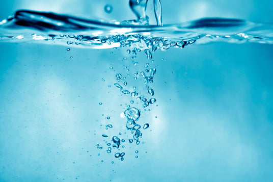 Water bubbles rising in a blue underwater scene.