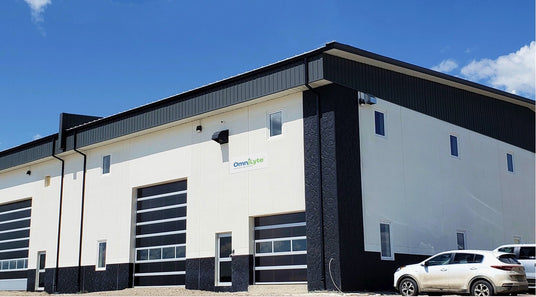 Exterior view of a commercial building with multiple large windows and a sign that reads "OmniLyte."