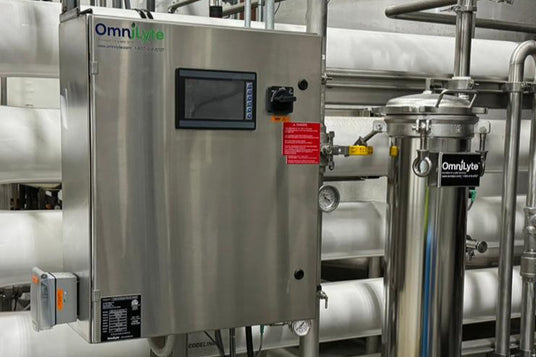 Steel control panel with digital display and gauges, connected to a filtration system, labeled "OmniLyte."