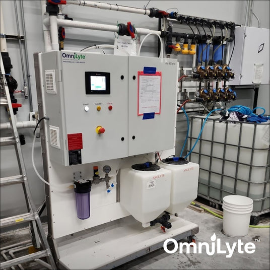 OmniLyte control unit with attached tanks and plumbing in an industrial setting.