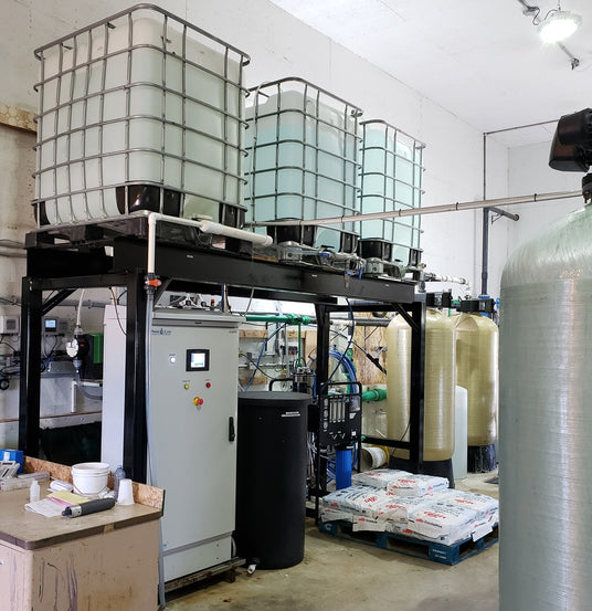 Industrial storage tanks and machinery in a workshop environment.