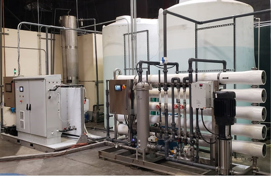 Industrial water treatment setup with various pipes and tanks.