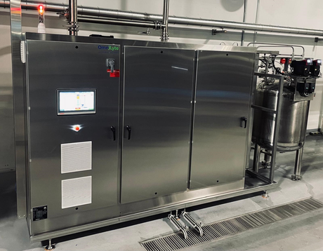 Stainless steel machine with a touchscreen interface and various valves and containers.