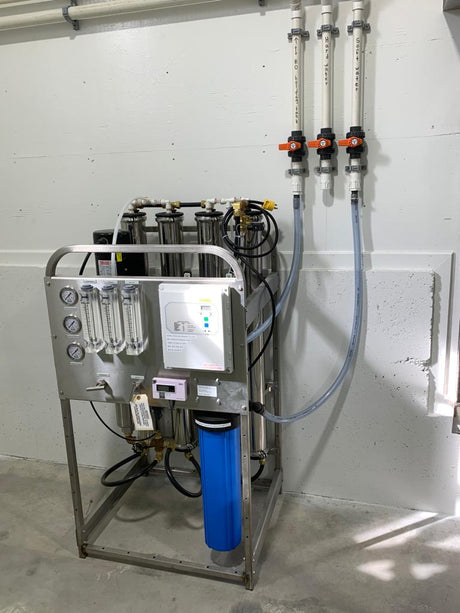 Water filtration system with multiple filters and control panel.