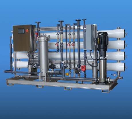 Industrial water treatment system with pipes, valves, and a control panel.