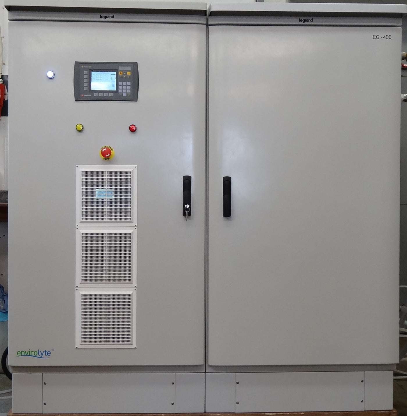 Gray industrial equipment with a digital display, buttons, and ventilation grilles.