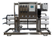 Water filtration system with stainless steel frame and multiple pressure gauges.