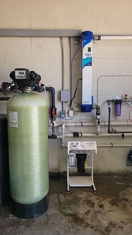 Water filtration equipment including a large tank and a UV treatment system.