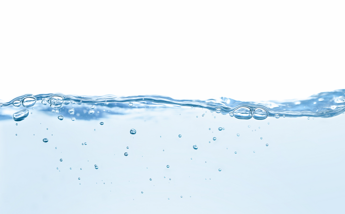 Water with bubbles rising against a white background.