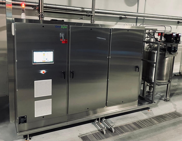 Stainless steel industrial machine with touchscreen display and connected components.