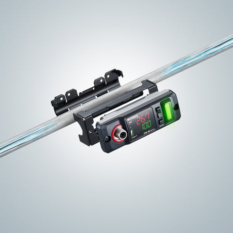 Digital display device mounted on a metal rod, showing measurements and indicators.