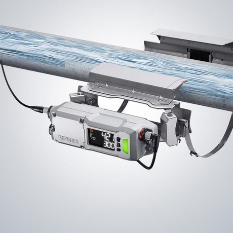 KEYENCE device mounted on a metal pipe, displaying measurements.