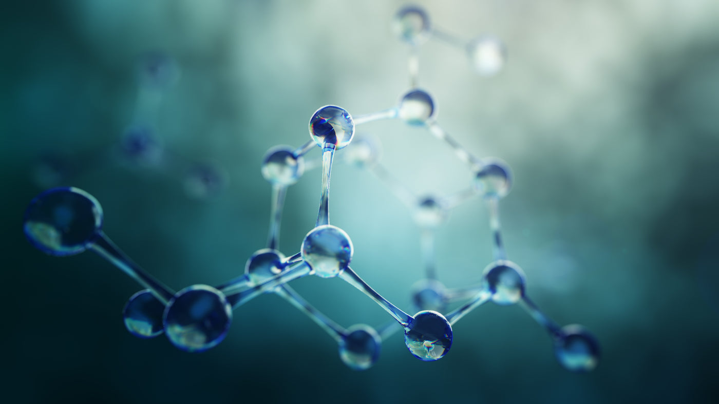 Molecular structure with translucent spheres and connecting lines against a blurred background.